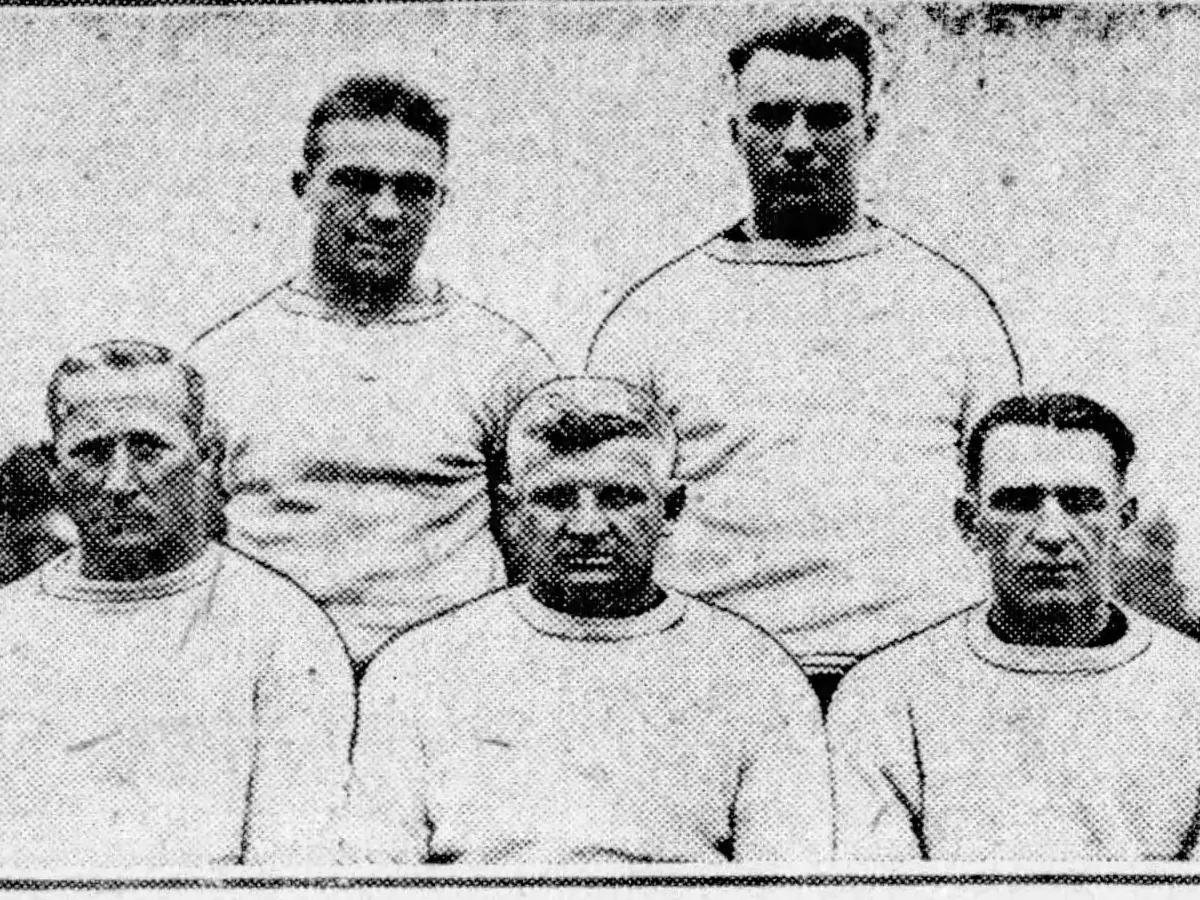 Representative image: Caption text says "Left to right, front row: Nate Cartmell, trainer; Hugo Bezdak, head coach; Glenn Killinger, assistant coach. Back row: Leo Houck, assistant trainer; Ray Baer, assistant coach."